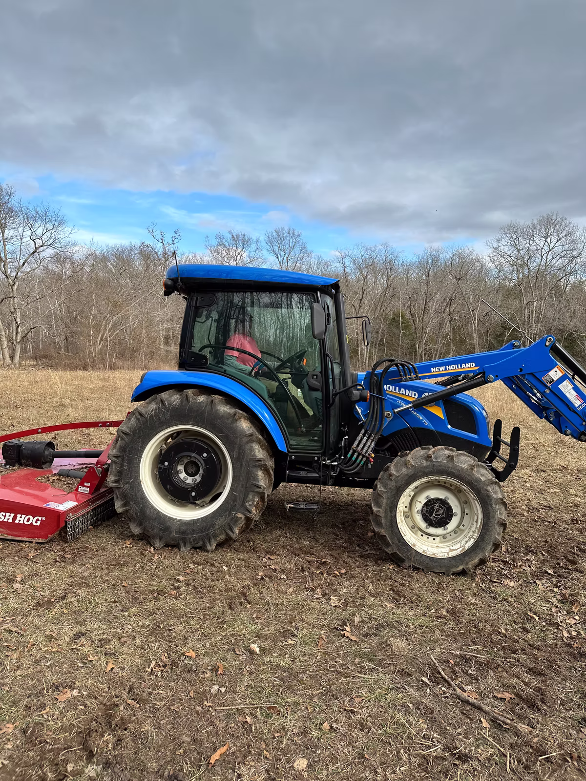 Shelley setting out to mow the 4 acres near the hogs